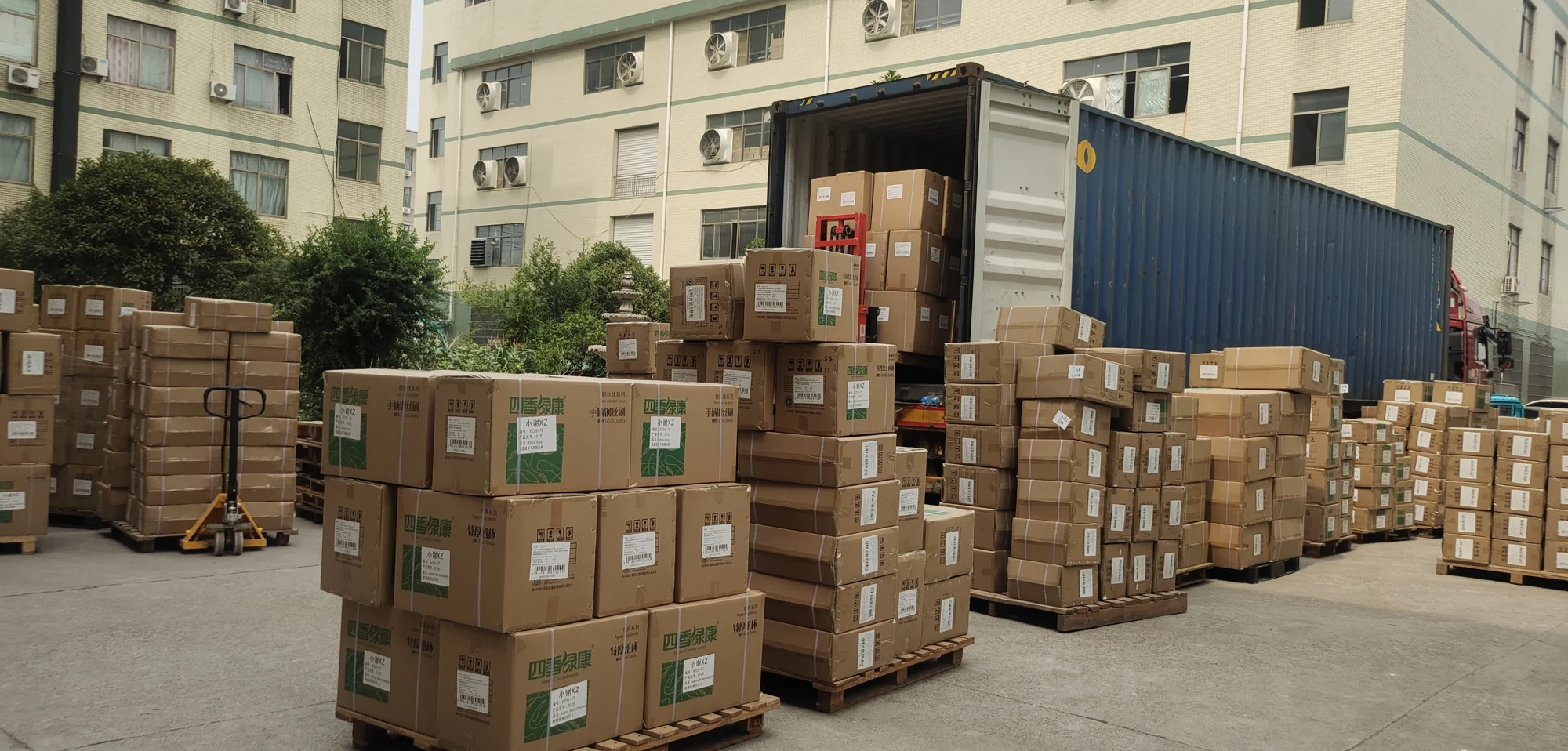 Supplier-provided photograph of packed cartons beside a shipping container